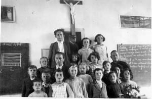 Compreignac May 1943; the class of children from Alsace with their teacher M.Cordary and the local priest. Solange is second row, first on right partially obscured by child in the front row.